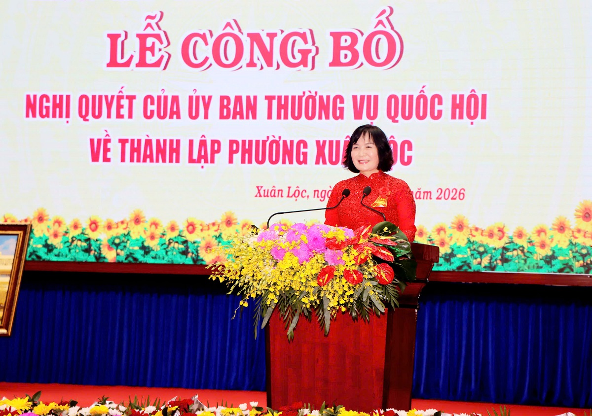 'A person standing at a podium with flowers

AI-generated content may be incorrect.'