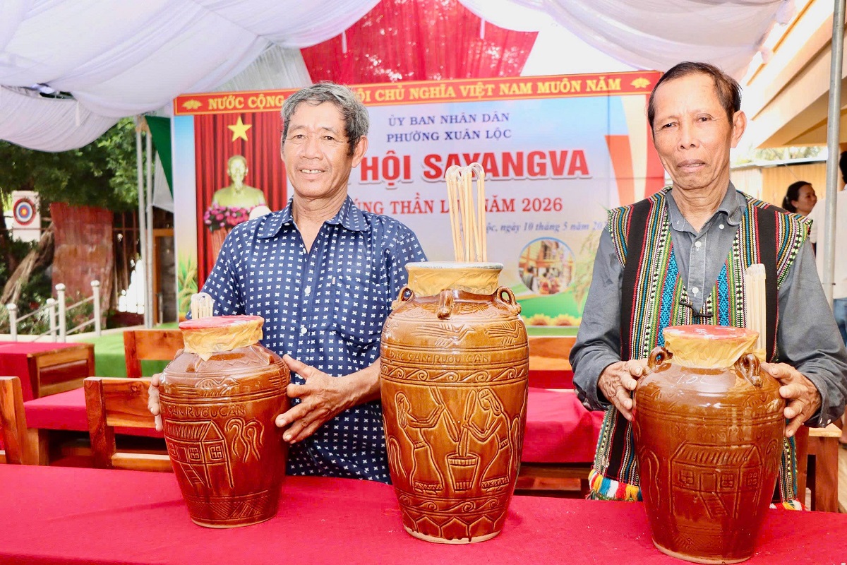 'Two men standing next to a table with large jars

AI-generated content may be incorrect.'