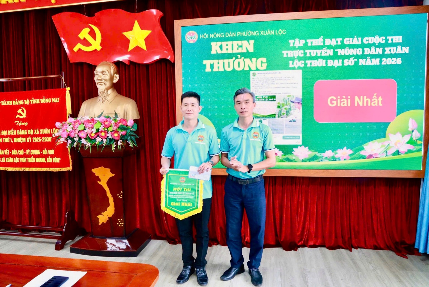 '''Two men standing in front of a banner

AI-generated content may be incorrect.'''